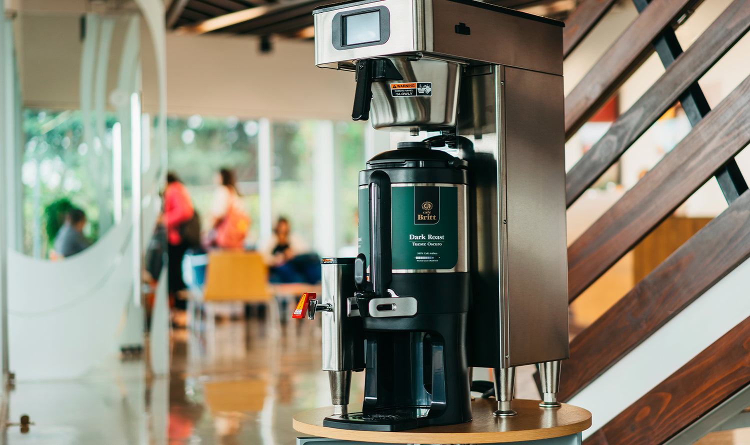 Commercial coffee brewer with Café Britt gourmet Costa Rican coffee in a office.