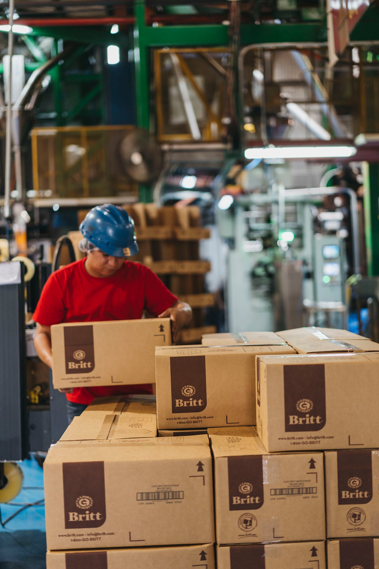 Person moving boxes of products in the warehouse