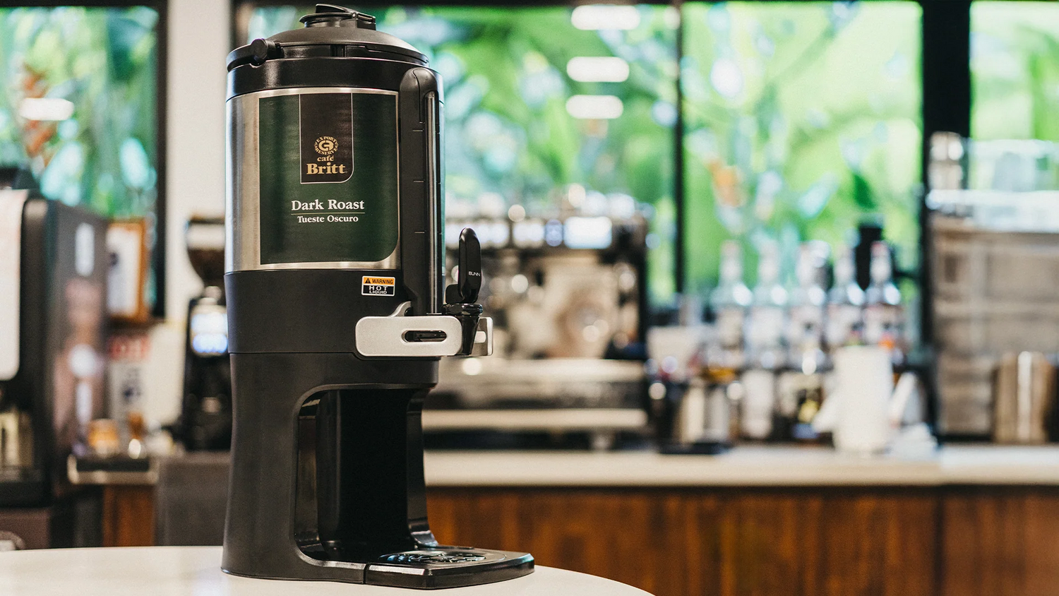 Black coffee machine on a blurred bar background