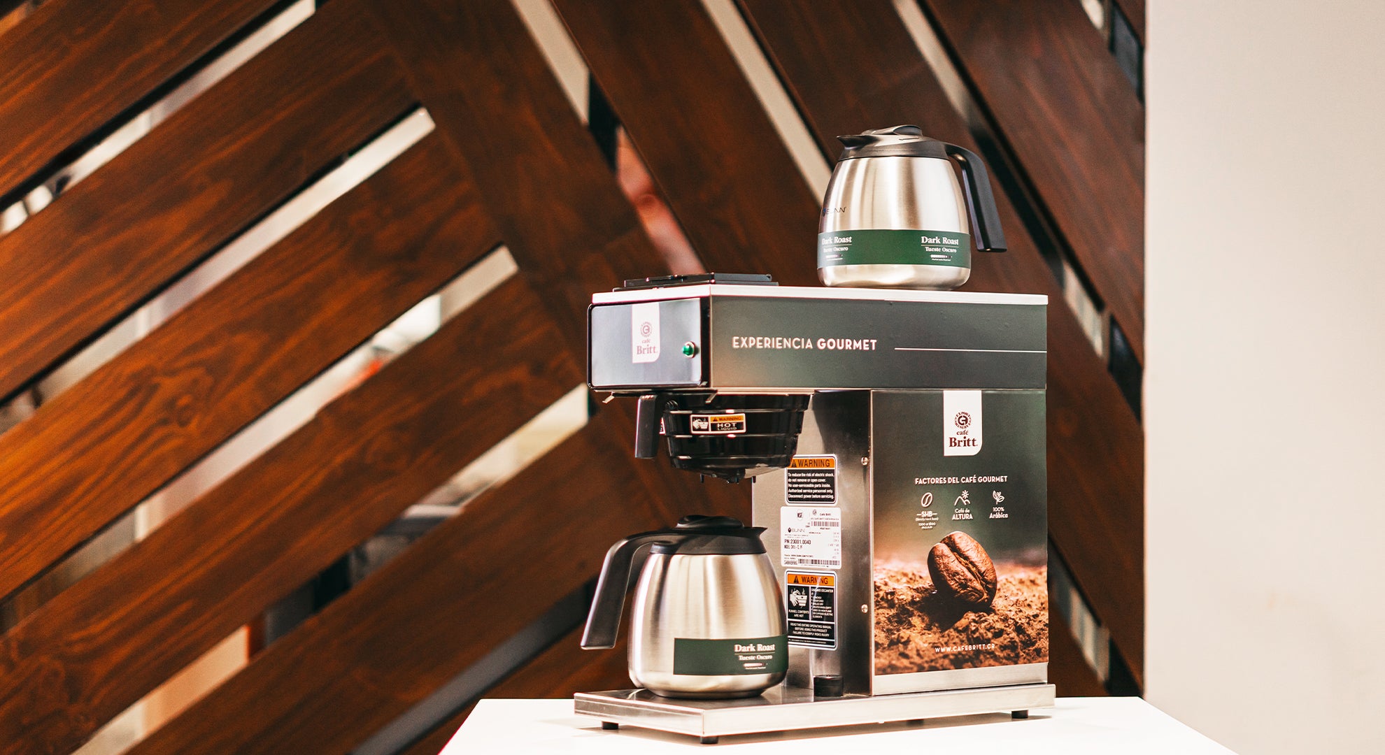 Coffee machine with a branded box on a wooden surface