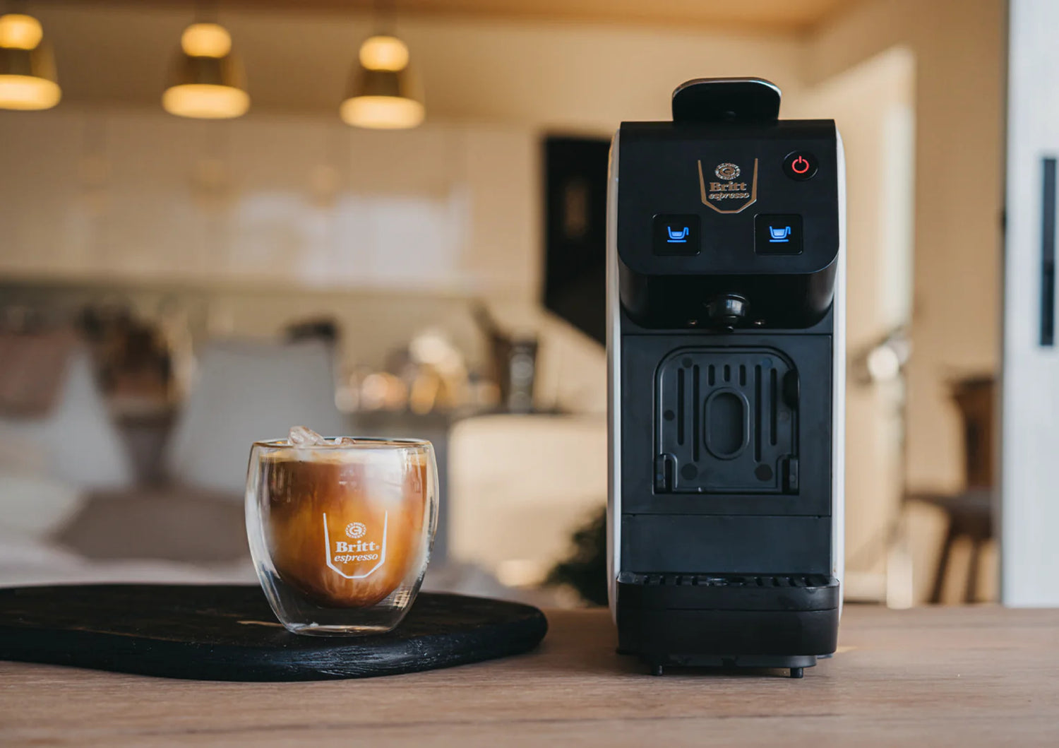 Coffee machine and glass of coffee on a table with a blurred background