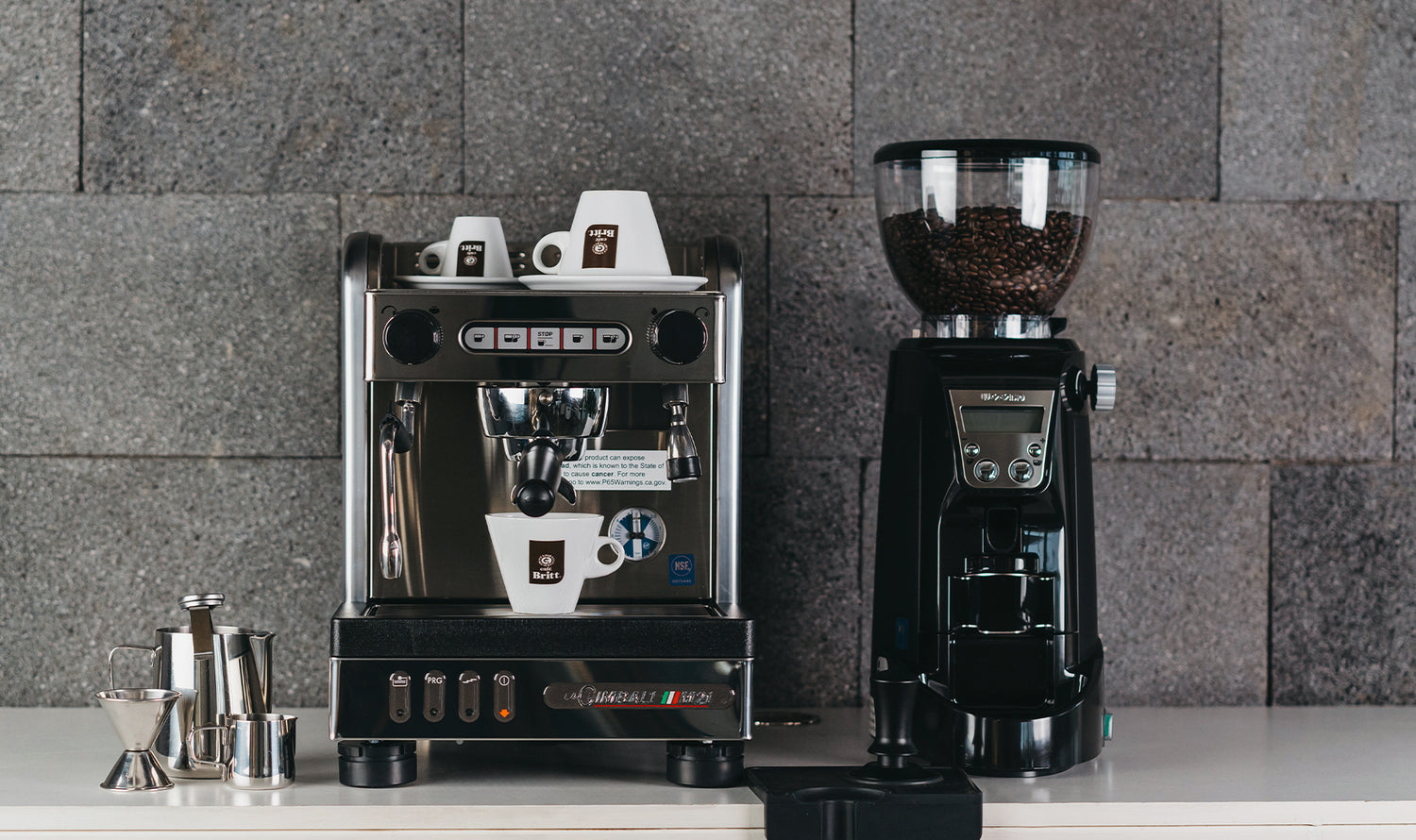 Commercial espresso machine and coffee grinder for Café Britt gourmet Costa Rican coffee.