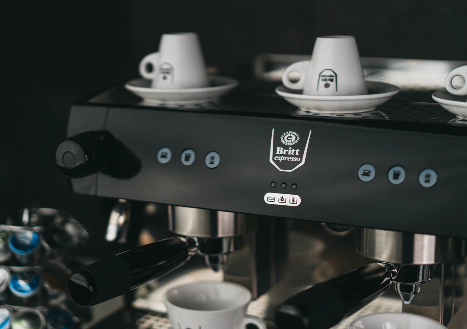 Espresso machine with two cups of coffee on a dark background